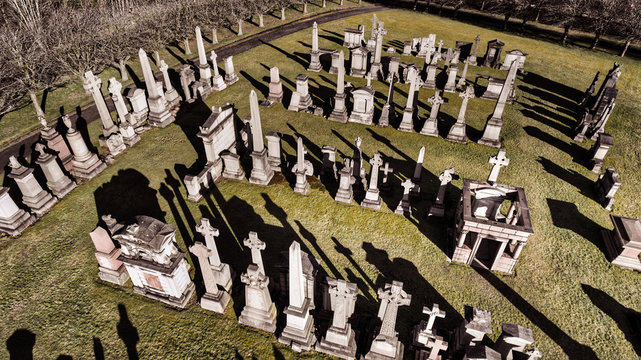 Aerial image of a low sun casting long shadows in Glasgow Necropolis. Victorian garden cemetery adjacent to Glasgow Cathedral.