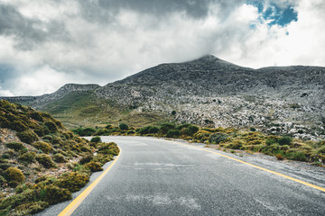 Crete, Greece, Path or street leading towards the mountains on an overcarst day in Rethymno...