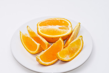 Fototapeta na wymiar Sliced orange on white plate with white background and room for copy text