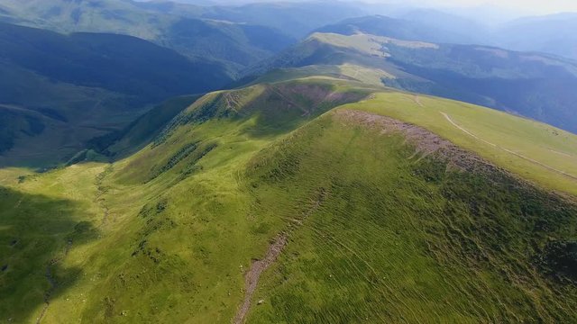 Aerial of a mountain range resembling a turtle shell in the Carpathians in summer