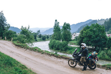 Motorcyclist man and Adventure Motorbike with beautiful mountains dirt road. Motorcycle trip. off road Traveling, Lifestyle Travel vacations sport outdoor concept.