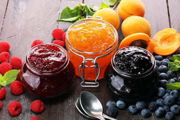 assortment of jams, seasonal berries, apricot, mint and fruits. marmalade or confiture