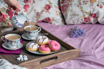 Breakfast in bed with coffee and donuts