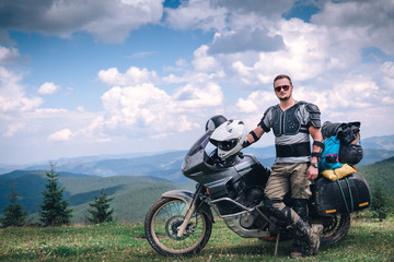 Fototapeta na wymiar Motorcyclist man and Adventure Motorbike on the top of the mountain. Motorcycle trip. off road Traveling, Lifestyle Travel vacations sport outdoor concept.