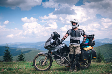 Motorcyclist man and Adventure Motorbike on the top of the mountain. Motorcycle trip. off road Traveling, Lifestyle Travel vacations sport outdoor concept.
