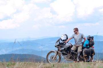 Motorcyclist man and Adventure Motorbike on the top of the mountain. Motorcycle trip. off road Traveling, Lifestyle Travel vacations sport outdoor concept.