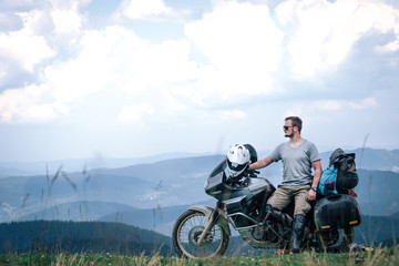 Fototapeta na wymiar Motorcyclist man and Adventure Motorbike on the top of the mountain. Motorcycle trip. off road Traveling, Lifestyle Travel vacations sport outdoor concept.