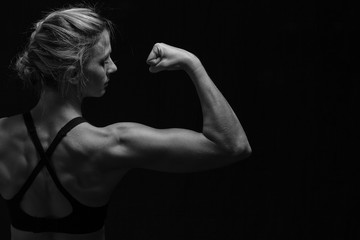 Fit woman with shaped muscles on back in artistic conversion