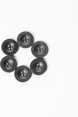 black buttons for sewing on a white background