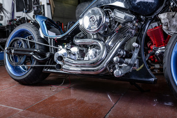 Detail on a modern motorcycle in the workshope. Motorcycle Exhaust. selective focus