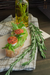 cherry tomatoes on a wooden background. Breakfast with toast and avocado, vegetarian cuisine, the concept of a healthy diet. 