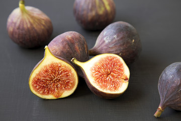 Fresh figs on dark surface, side view. Close-up.