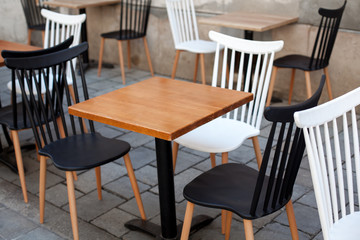 View of empty outdoor terrace cafe outdoor with retro wooden chairs and table in sunny summer day