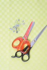 Scissors and threads on fabric, top view Tailoring equipment