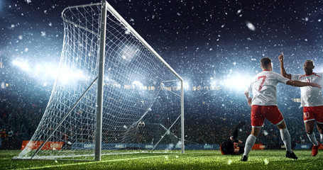 Intense soccer moment in front of the goal on the professional soccer stadium.