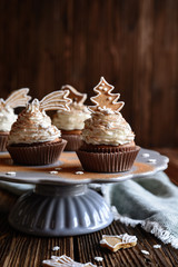 Gingerbread cupcakes decorated with cinnamon and Christmas cookies and snowflake sprinkles