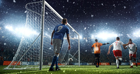 Intense soccer moment in front of the goal on the professional soccer stadium.
