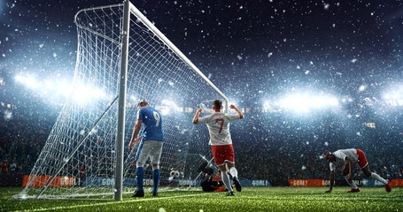 Intense soccer moment in front of the goal on the professional soccer stadium.