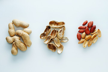 Evolution. Peanuts from the nut in the shell - to the peeled. On a white background