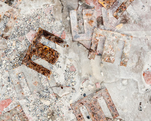 Abstract background with rusty metal shapes, the letter E, M, W or number 3. Rusty browns, pink and white, rough and smooth textures