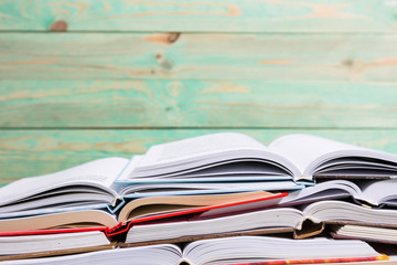 Pile of various books on wooden background