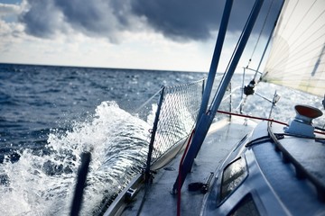 Stormy weather on the sea. A view from the sailboat's deck to the bow, Norway