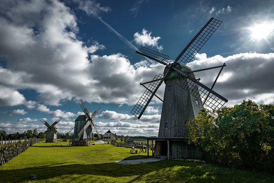 View towards Collection of old windmills at Angla Windmill Hill on a sunny day with blue sky and clouds in Saaremaa, Estonia