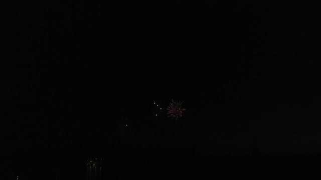 Aerial footage of fireworks over water. Rhine, Hesse, Germany.