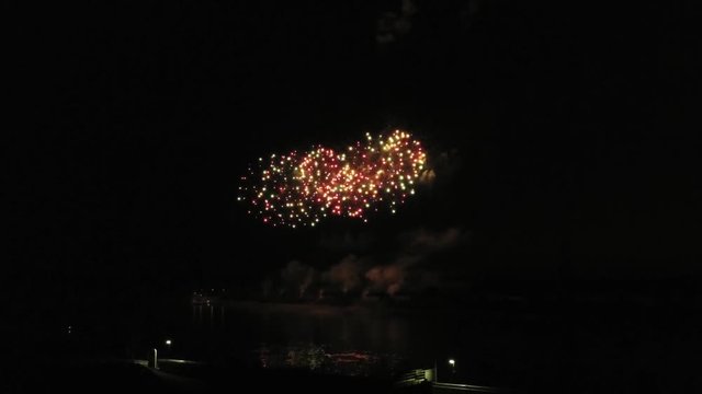 Aerial footage of fireworks over water. Rhine, Hesse, Germany.