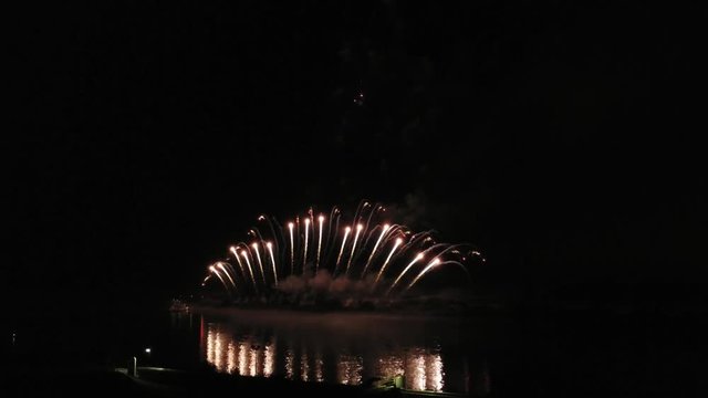 Aerial footage of fireworks over water. Rhine, Hesse, Germany.