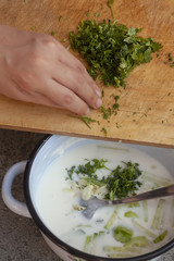 Tzatziki - yoghurt sauce with cucumber and dill on a slate or stone background. Top view with copy space.