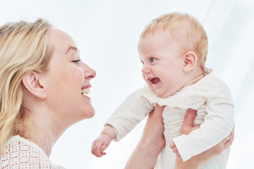 Parenting family. mother playing with little newborn baby