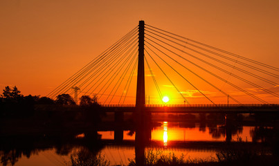 Obraz premium Steel cable bridge at sunrise over the river elbe