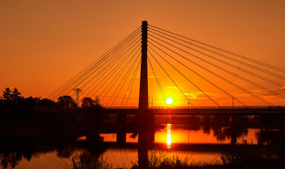 Steel cable bridge at sunrise over the river elbe