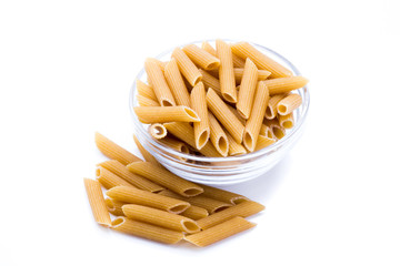 Container with wholemeal pasta isolated on a white background