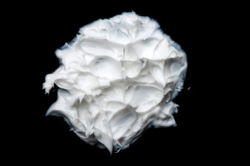 white cream on a black background