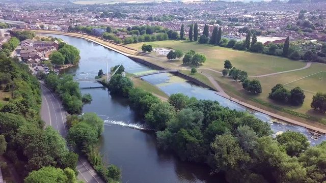 Flying over the beautiful River Exe in Exeter, England, with cityscape background