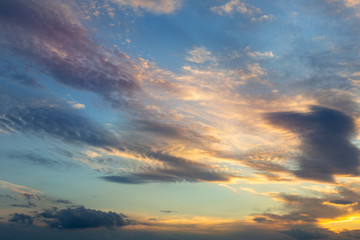 Fototapeta premium Kolorowe żywe dramatyczne niebo z pomarańczowymi do niebieskich chmur kolorów. Czas zachodu słońca. Piękny natury tło
