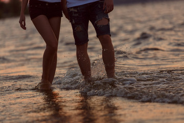couple walks along the seacoast.
man and woman walk along the waterfront
