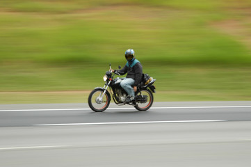 Obraz na płótnie Canvas speedy courier delivery biker resting one arm