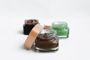 Assortment of different jams in small jars on white background, top view