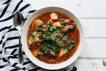 Delicious tomato soup with parsley, meat and pepper