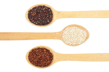 Black red white quinoa seeds in wooden spoon isolated on white background. Top view
