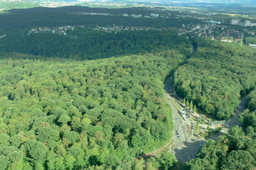 Amazing Landscape view on the beautiful forests, alpine mountains and idyllic fields of South Germany with a blue sky before sunset with clouds city view from the top