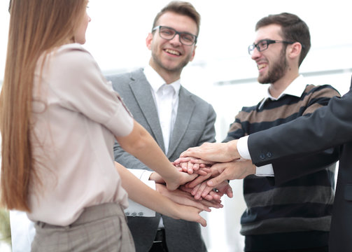 Business team standing joining hands together