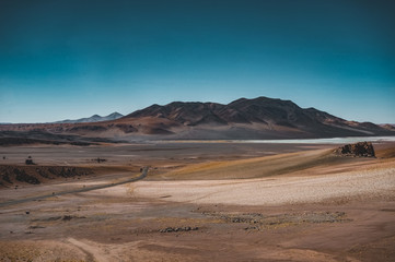Fototapeta na wymiar Street Atacama Desert Chile with mountain and blue Sky