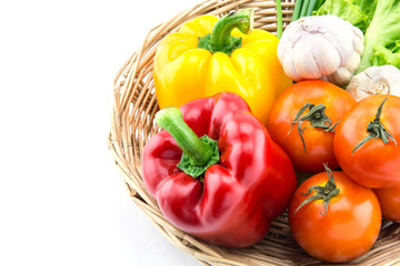 Organic vegetables in the wicker basket on white background