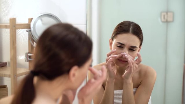 Problem Skin. Woman Crushing Spot On Face And Looking In Mirror