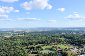 Fototapeta premium Amazing Landscape view on the beautiful forests, alpine mountains and idyllic fields of South Germany with a blue sky before sunset with clouds