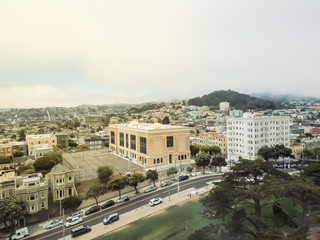 Aerial view famous Alamo Square in Western Addition neighborhood, San Francisco, California, USA. Famous hillside park Alamo Square attraction with typical Victorian houses and crowd of tourists